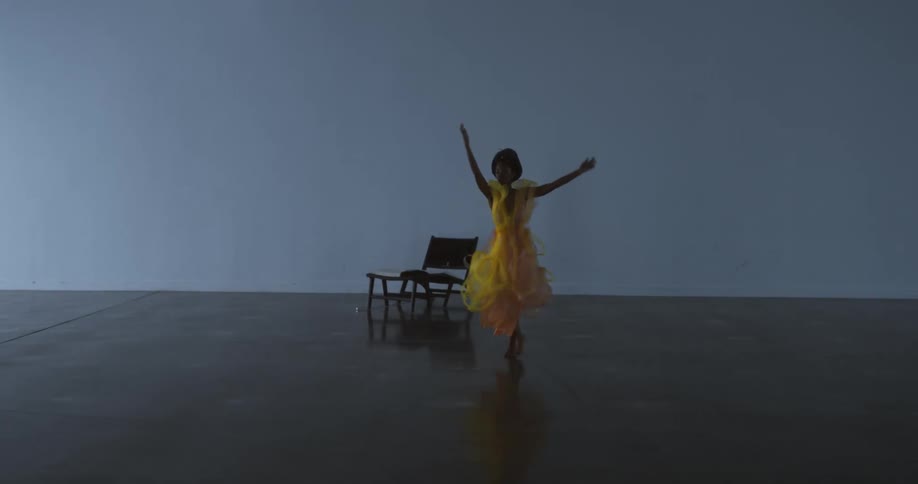 Female dancer performs on reflective stage