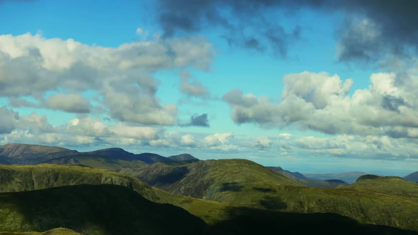 Landscape of green mountains and clouds floating