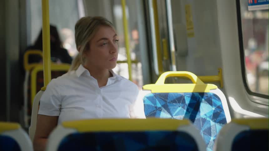 A woman is riding the bus