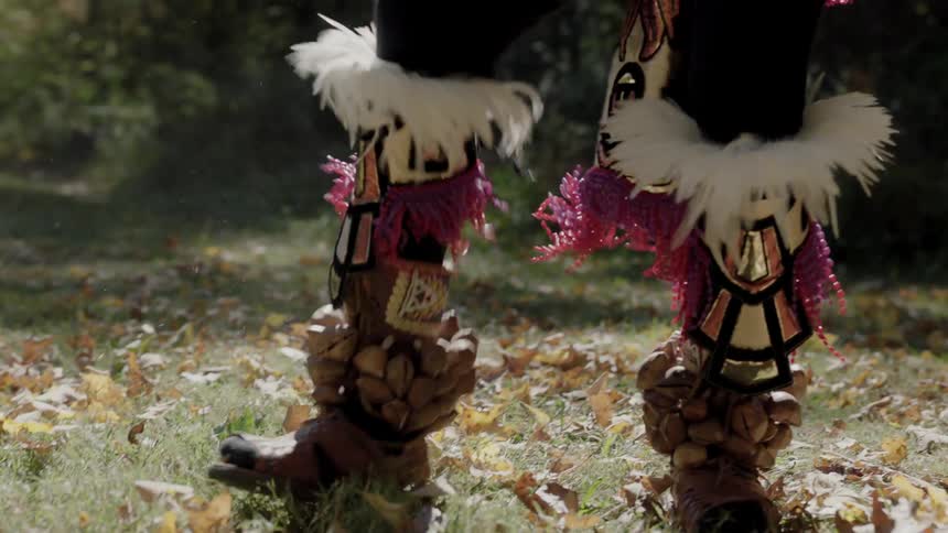 Elaborately designed boots worn by a man dancing