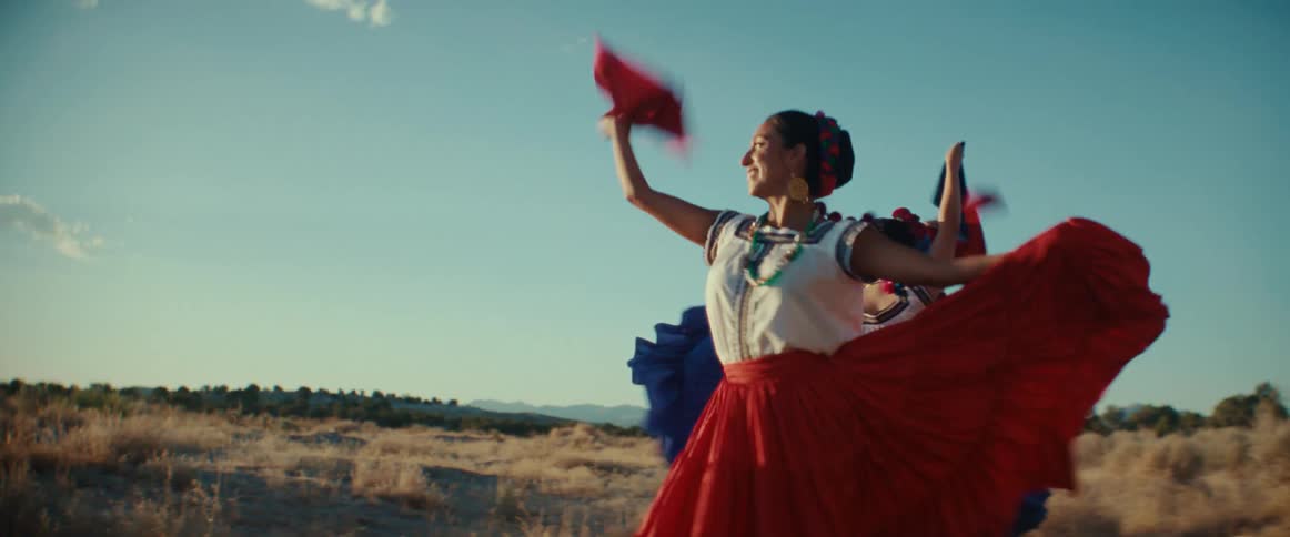 A group of women perform a traditional Mexican folk dance in traditional clothing