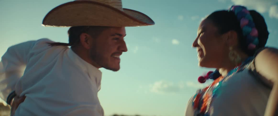 Group of dancers performing a traditional latin american folk dance outdoors at sunset