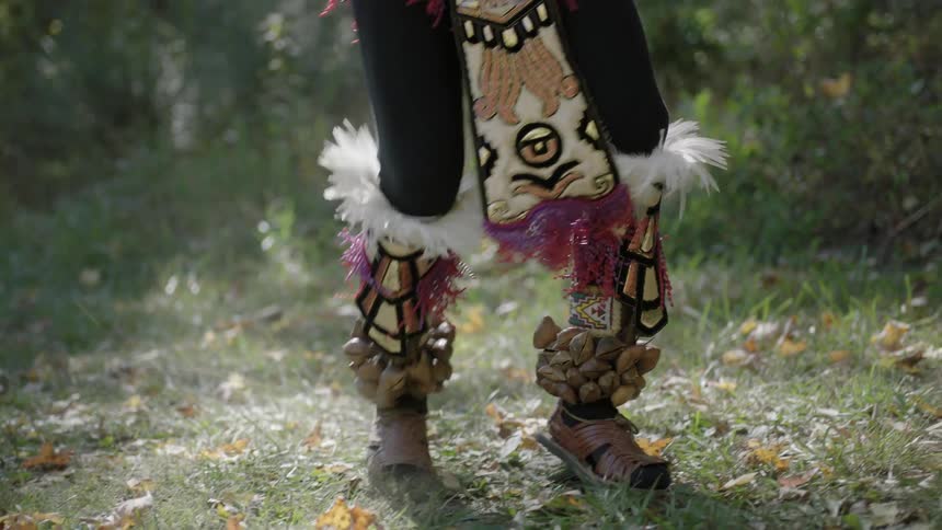 A person dances in the leaves