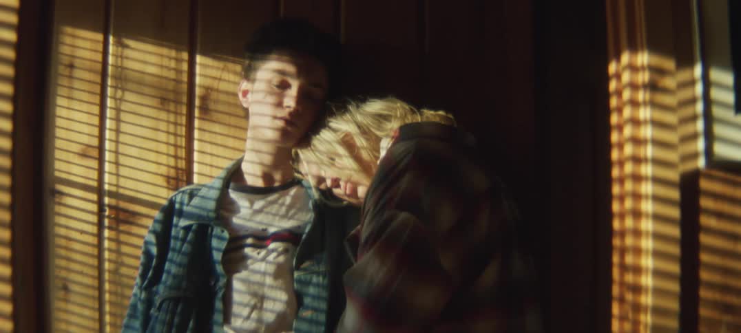 A girl leans against a man
