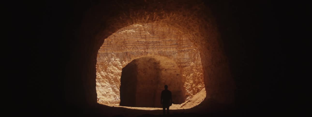 A man walks through a cave