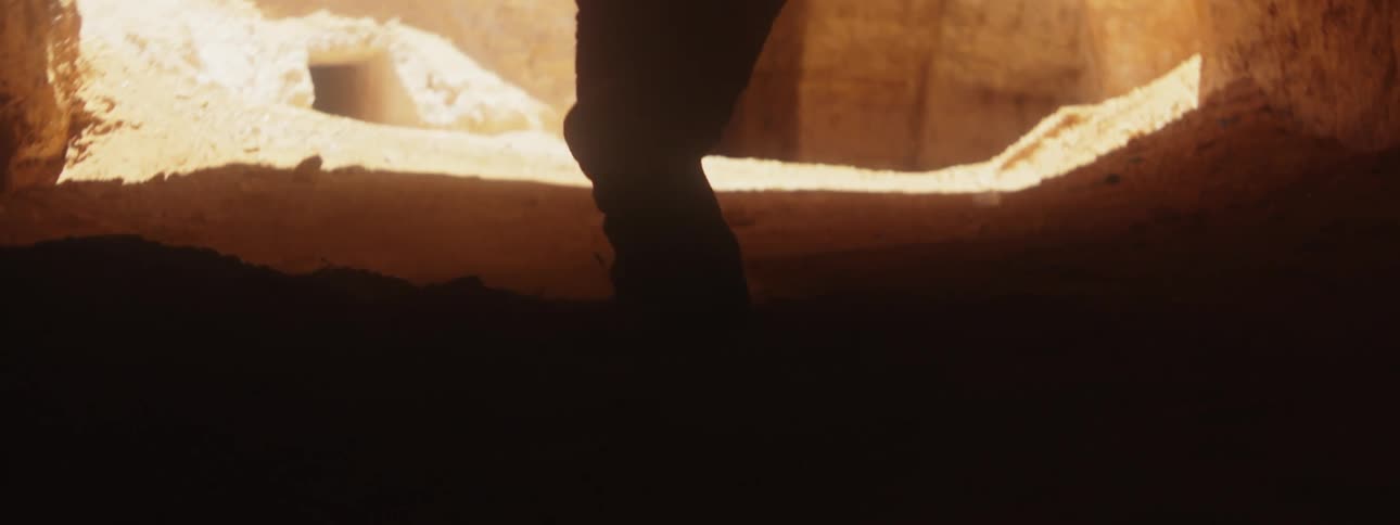 A person is walking through the cave
