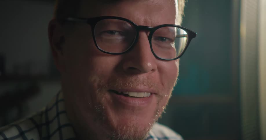 A man looks up and smiles