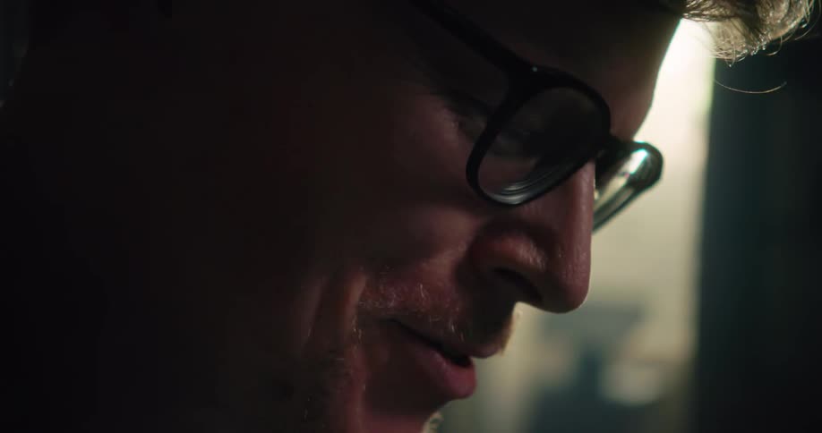A man smiles as he talks