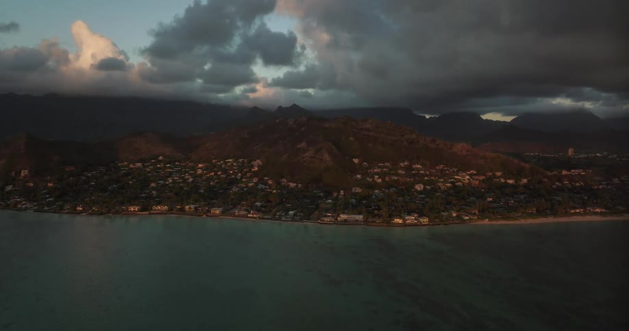 City sits between shore and mountain on cloudy day