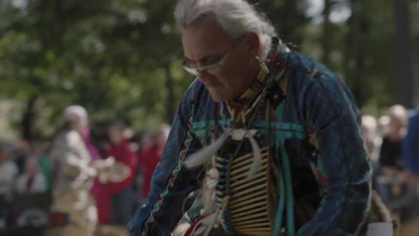 A native american dances outside