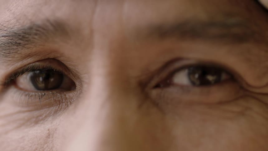 An older person's eye look at the camera