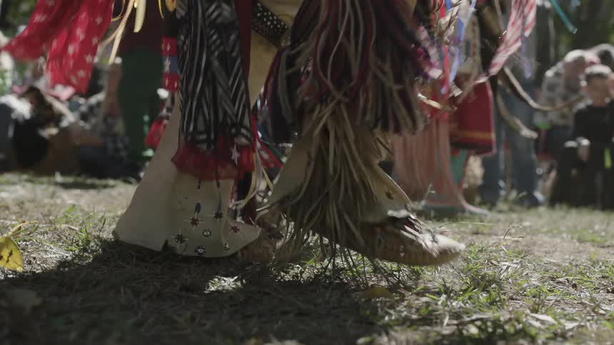 A person dances on the grass