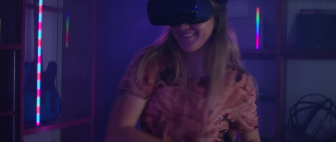 Man and woman play virtual tennis wearing vr headsets