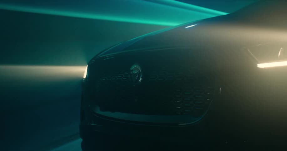 Black sports car with bright headlights on driving on a laser light tunnel surrounded by smoke