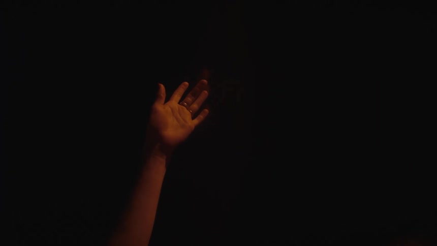 A persons hand in a room
