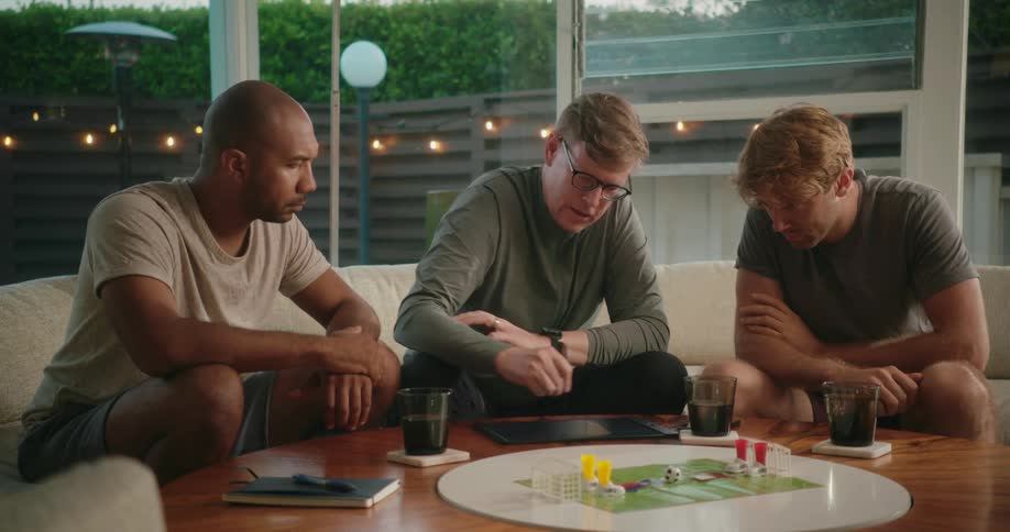 Three friends are sitting around a table together