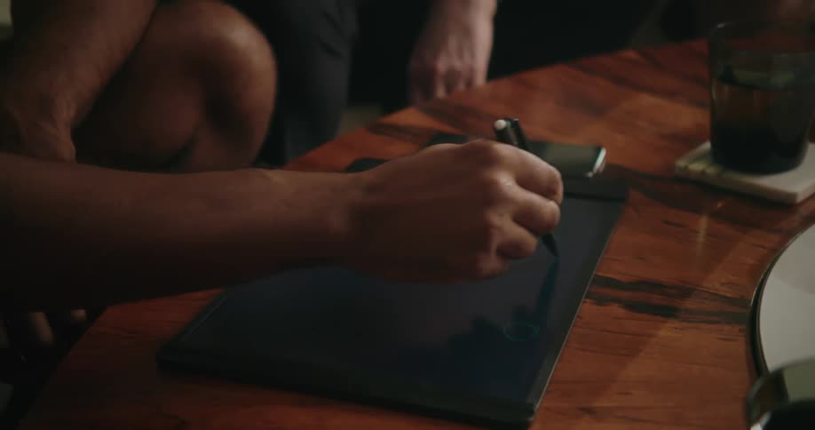A man is drawing on the tablet