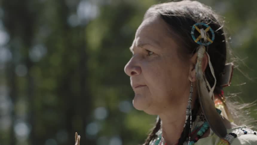 A native american woman walks on a sunny day
