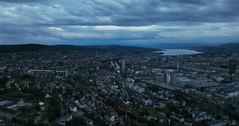 An aerial view of a city skyline with a lake in it