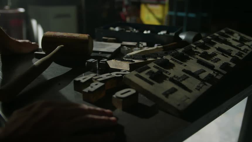 A man pushes a cart full of tools through a warehouse