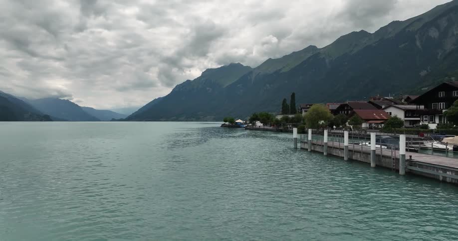 A large dock in a small town is on a mountain lake