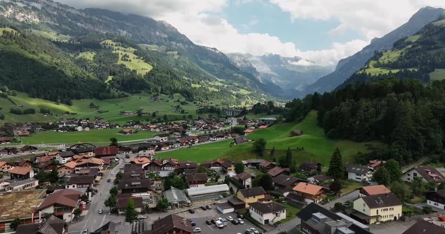 Traffic moves along a street in a mountain town