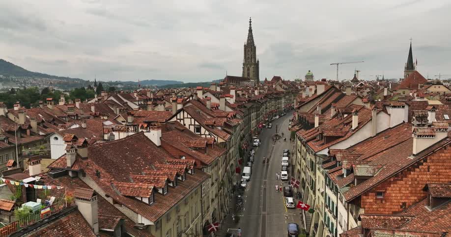 People walk down a busy city street in a historical neighborhood