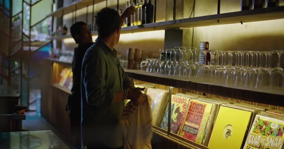 Two men clean glasses in the bar