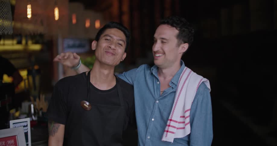 Two men laugh in the restaurant