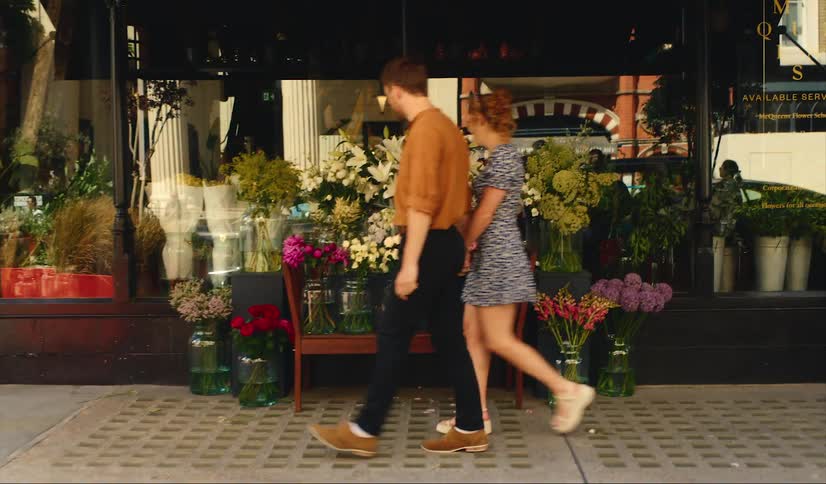 Young couple walk flower shop in Mayfair, London