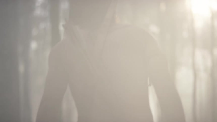 Tribal man walking slowly through a smokey forest