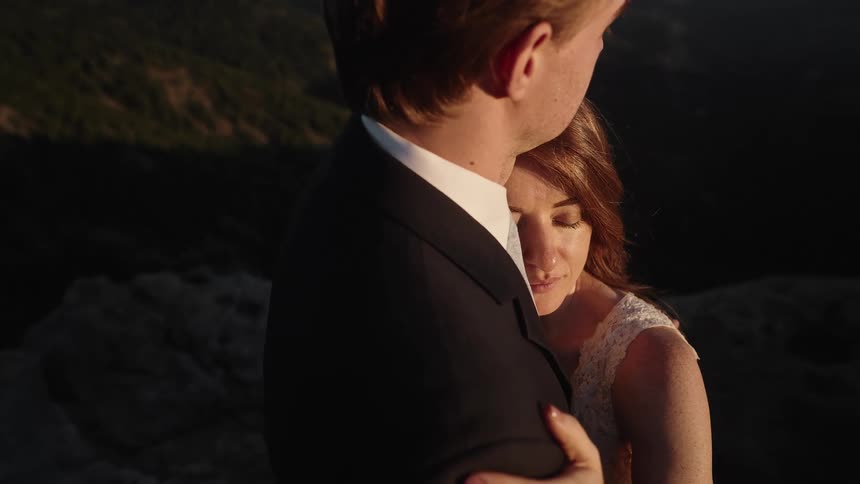 A man and woman hugging outside