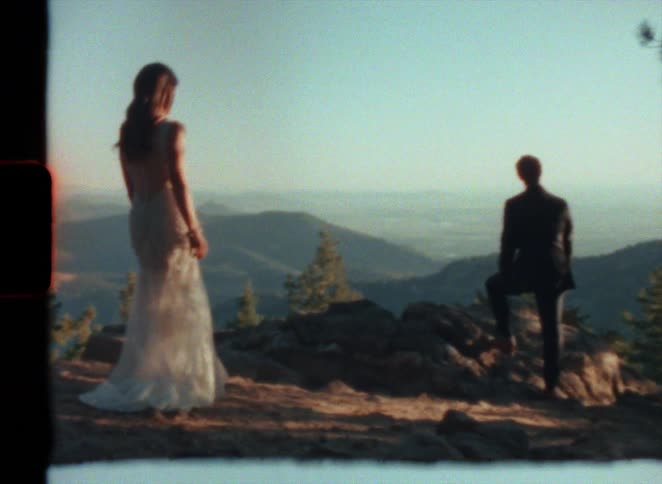 A bride in a gown approaching the groom outside caught on vintage super 8 film