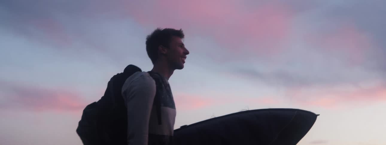 A man is carrying a surfboard