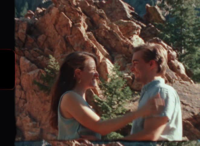 A woman kisses her boyfriend in a canyon in super 8 film
