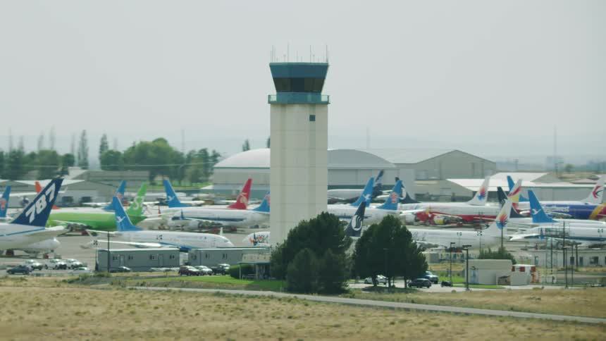 Several airplanes are parked on the tarmac of an airport