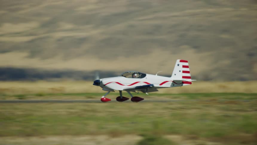 A small single engine airplane rolls down the runway after landing