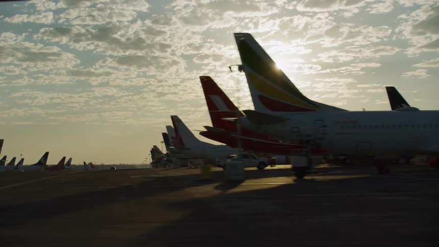 Hundreds of passenger planes sit parked in an airfield