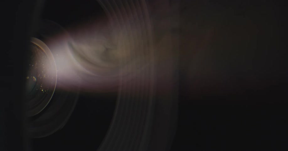 Light beam emiting from projector reveals circling vapors