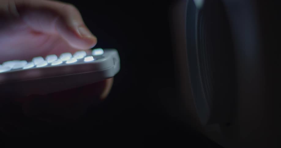A person is using a television remote