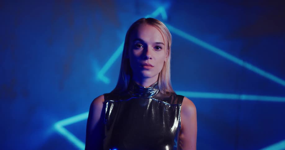 A young white blonde woman is posing for a photoshoot