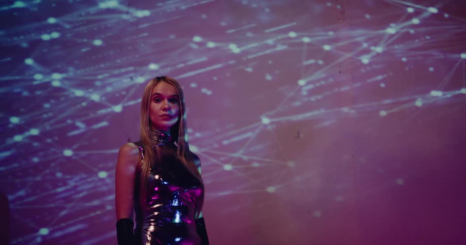 A model poses in front of a projected digital design