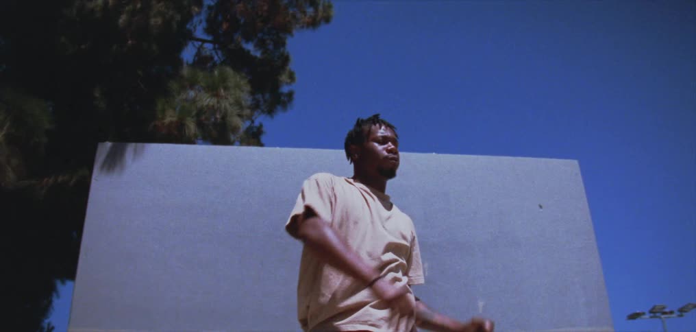 A man is standing outdoors and practicing a dance