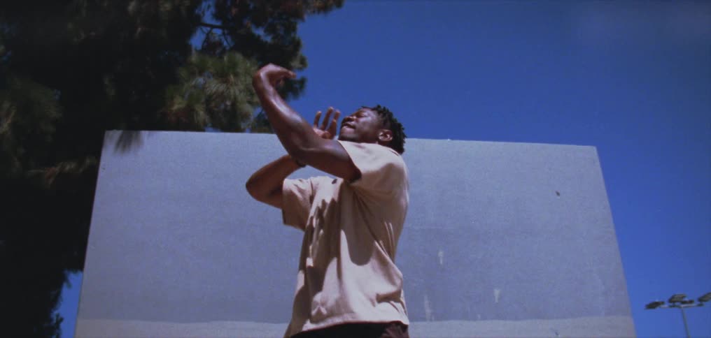 A man is dancing by the wall