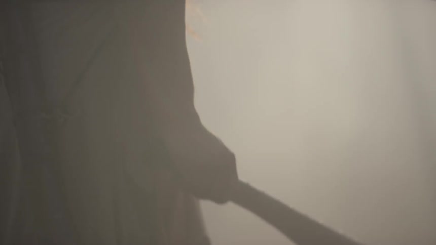 Tribal man standing in a smoky forest