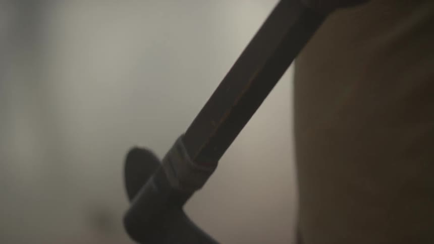 A person is holding a hatchet