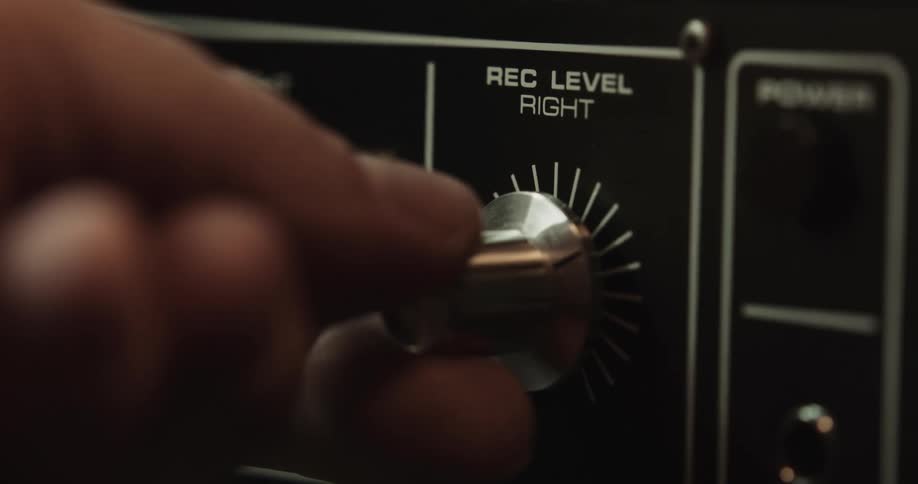 Person sets recoding level on right using dial