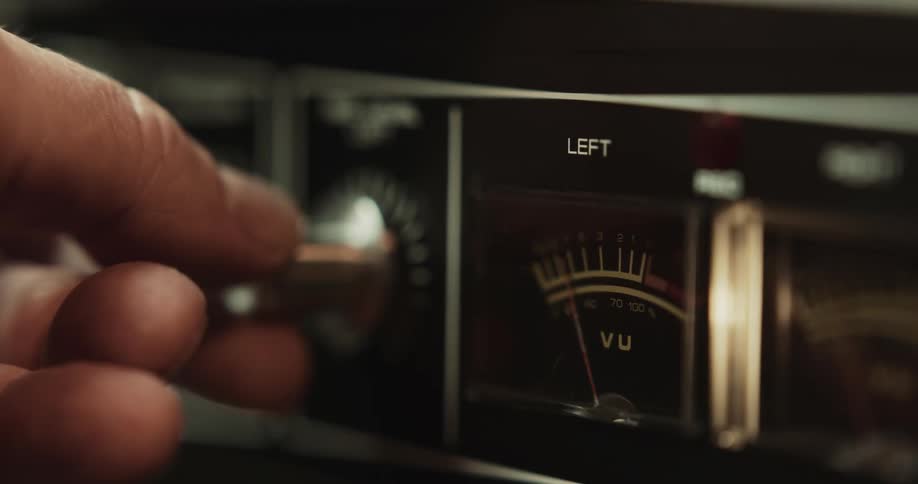 A person is turning the station on a radio