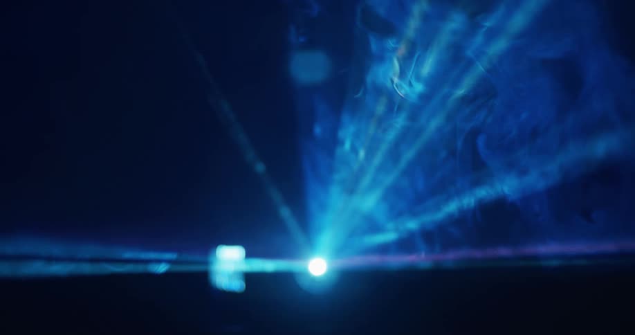 Projector blue color spotlight with smoke texture in dark room