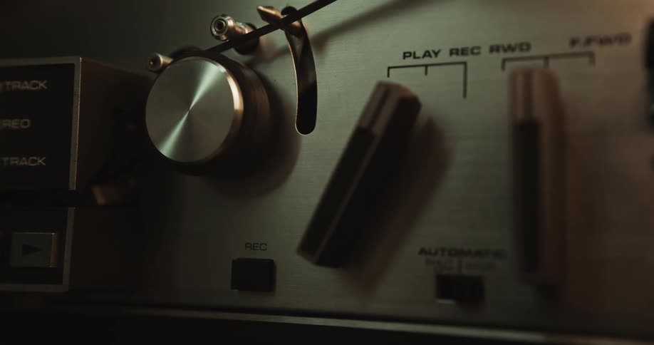 A person is turning buttons on a piece of technology